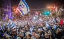 Crowds of protesters wave flags during a demonstration against the proposed judicial reforms in Tel Aviv on January 21, 2023. (Photo by Eyal Warshavsky/SOPA Images/LightRocket via Getty Images)