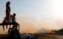 Israeli children look at fire after a kite was reportedly sent by Palestinian protesters from across the border to burn fields in Kibbutz Beeri near the border with the Gaza Strip on June 5, 2018. MENAHEM KAHANA/AFP via Getty Images